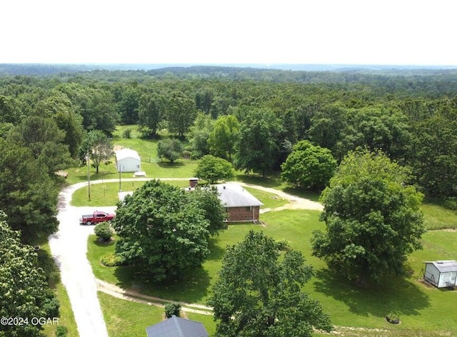 drone / aerial view featuring a view of trees
