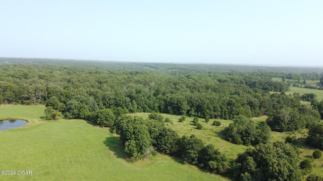 bird's eye view featuring a view of trees and a water view