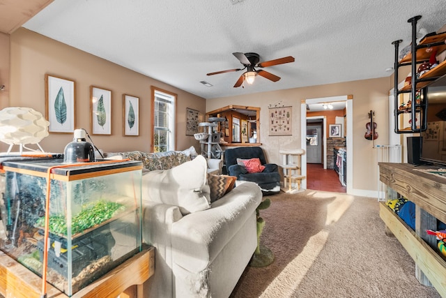 living room with a ceiling fan, baseboards, visible vents, a textured ceiling, and carpet flooring