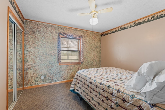 bedroom featuring carpet flooring, a textured ceiling, crown molding, and baseboards