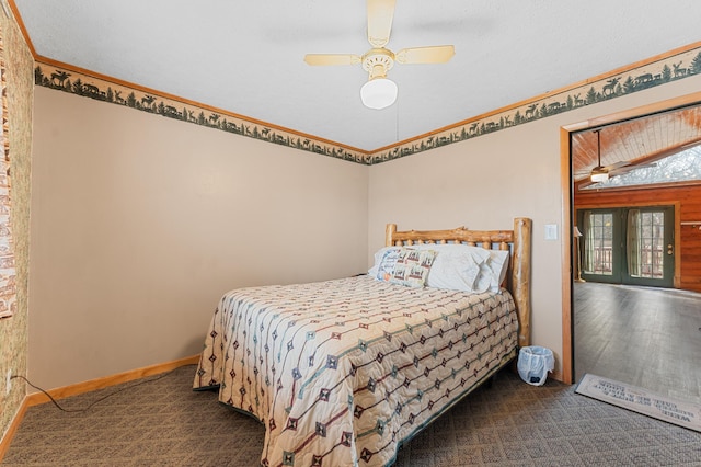 bedroom featuring baseboards, a ceiling fan, carpet flooring, and crown molding