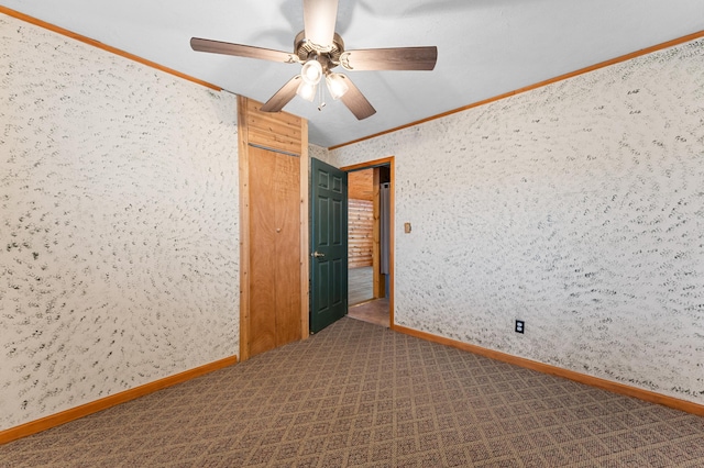 spare room with ceiling fan, baseboards, carpet, and ornamental molding