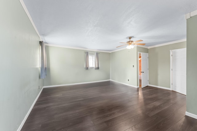 unfurnished room featuring crown molding, wood finished floors, baseboards, and ceiling fan