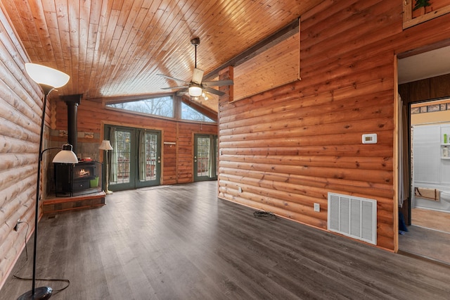 unfurnished living room featuring visible vents, a ceiling fan, wood finished floors, wooden ceiling, and a wood stove