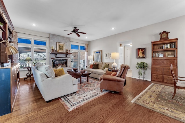 living area with recessed lighting, a fireplace, baseboards, ceiling fan, and dark wood-style flooring