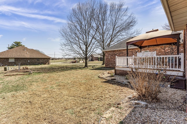 view of yard featuring a gazebo and a wooden deck