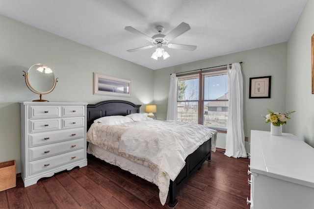 bedroom with a ceiling fan and dark wood-style floors