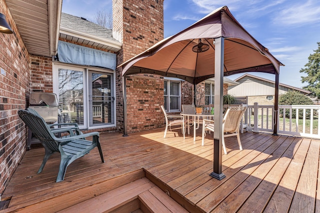 wooden terrace featuring outdoor dining space