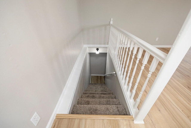 stairway with wood finished floors