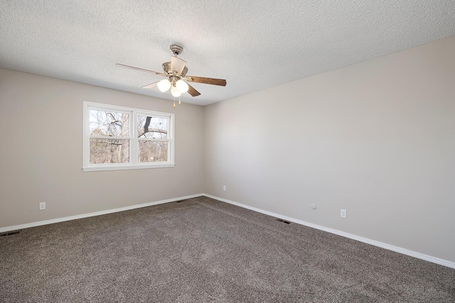 unfurnished room featuring visible vents, baseboards, dark carpet, a textured ceiling, and a ceiling fan