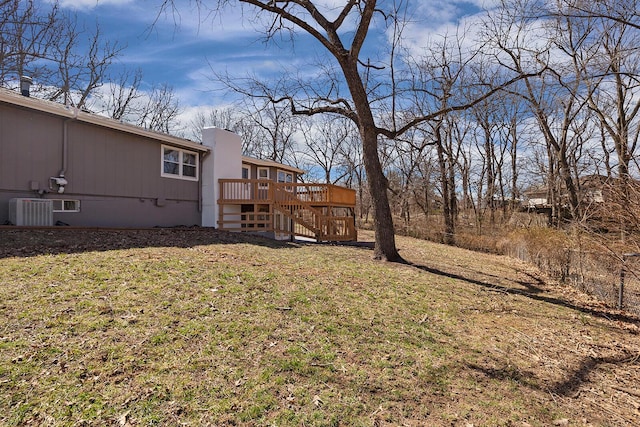 view of yard featuring central AC unit, a wooden deck, and stairs