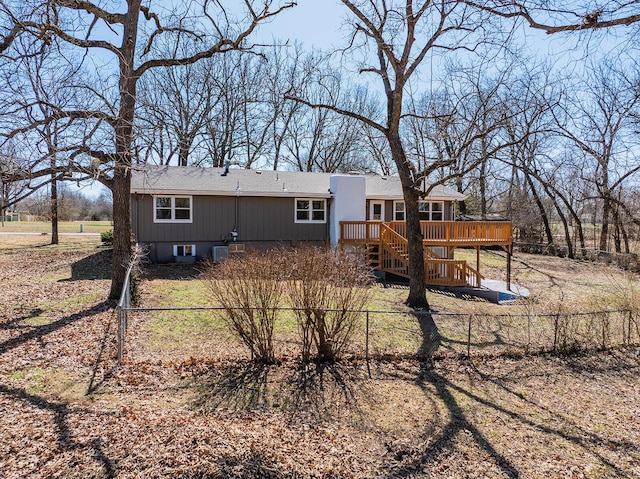 rear view of house with a wooden deck and fence private yard