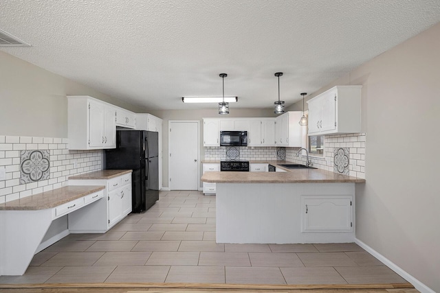 kitchen with visible vents, black appliances, a sink, white cabinetry, and a peninsula