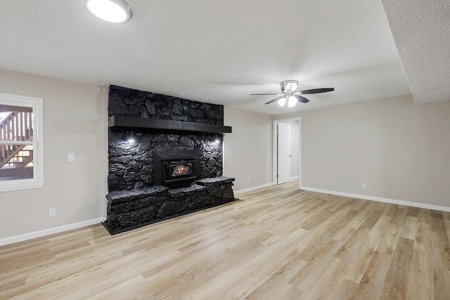 unfurnished living room featuring wood finished floors, baseboards, and ceiling fan