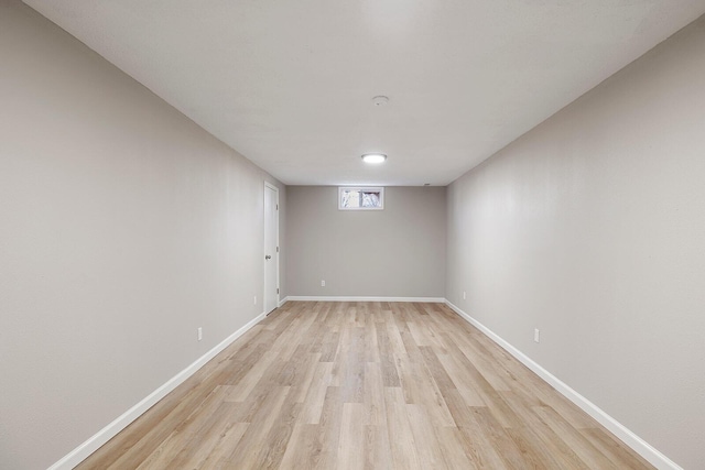 unfurnished room featuring baseboards and light wood-style floors