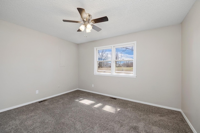 unfurnished room featuring visible vents, a ceiling fan, a textured ceiling, carpet, and baseboards