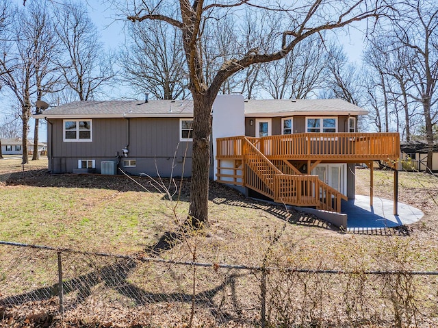 rear view of property with stairway, a patio, a deck, and fence