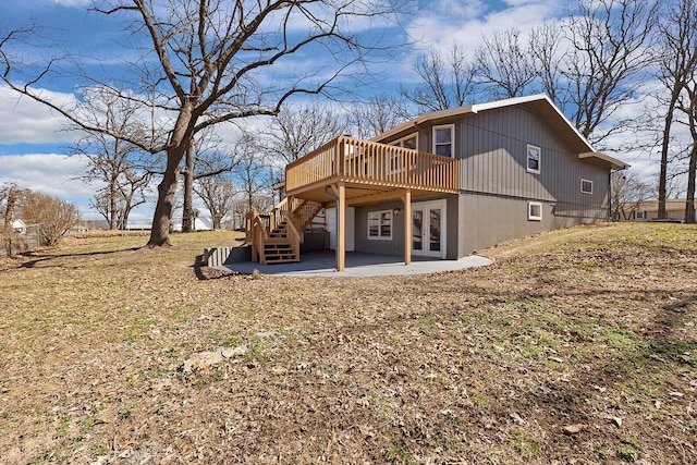 back of property with a patio area, stairway, french doors, and a wooden deck