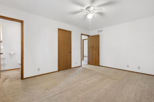 empty room with visible vents, baseboards, light colored carpet, and ceiling fan