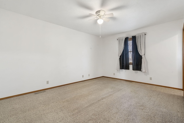 unfurnished room with visible vents, baseboards, carpet, and ceiling fan