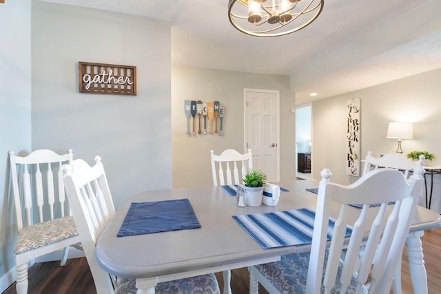 dining room with a notable chandelier and wood finished floors