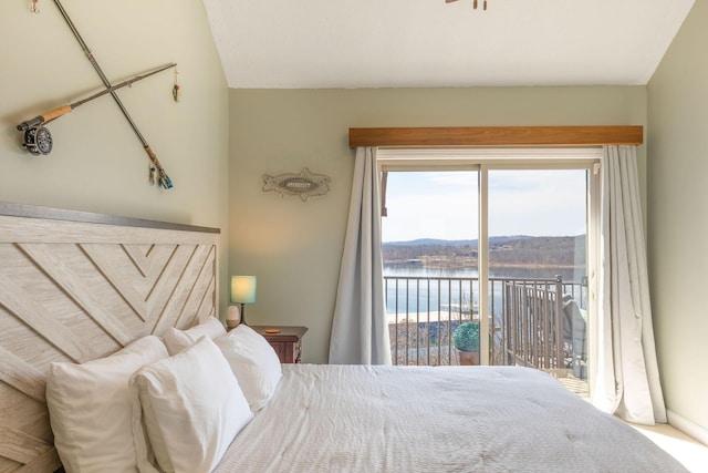 bedroom featuring access to outside and a water view