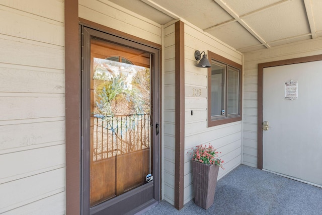 view of exterior entry with covered porch