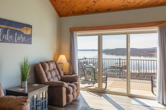 living room with wooden ceiling, plenty of natural light, wood finished floors, and a water view