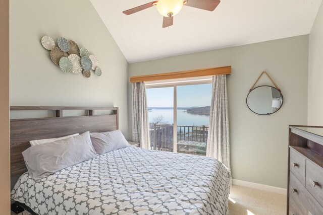 carpeted bedroom featuring ceiling fan, lofted ceiling, baseboards, and a water view