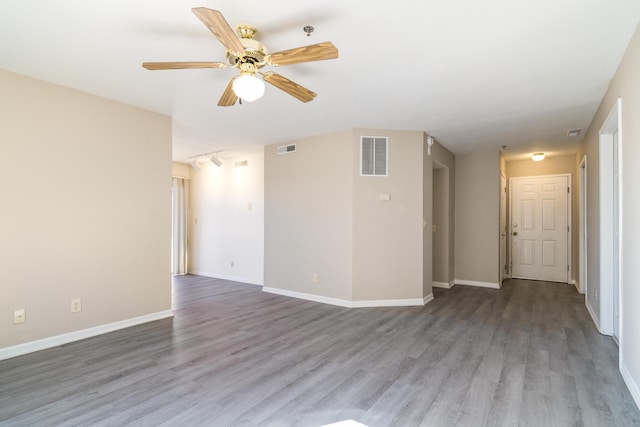 unfurnished room with visible vents, wood finished floors, baseboards, and ceiling fan