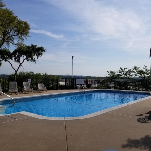 pool featuring a patio and fence