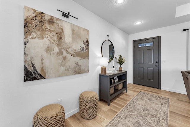 entrance foyer with recessed lighting, baseboards, and light wood finished floors