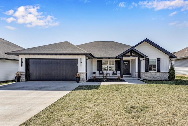 view of front of house featuring driveway, a front lawn, stone siding, an attached garage, and a shingled roof