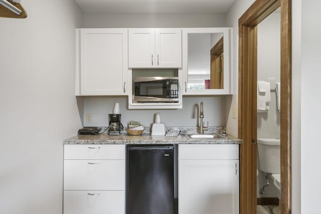 982 Indian Point Rd Unit 313, Indian Point, MO 65616 - kitchen with stainless steel microwave, white cabinets, light stone counters, and a sink
