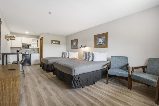 bedroom with a sink, light wood-type flooring, and recessed lighting