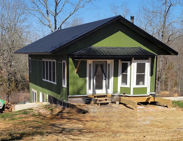 view of front of home featuring metal roof, a garage, and entry steps