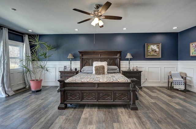 bedroom with dark wood finished floors, a wainscoted wall, recessed lighting, and a ceiling fan