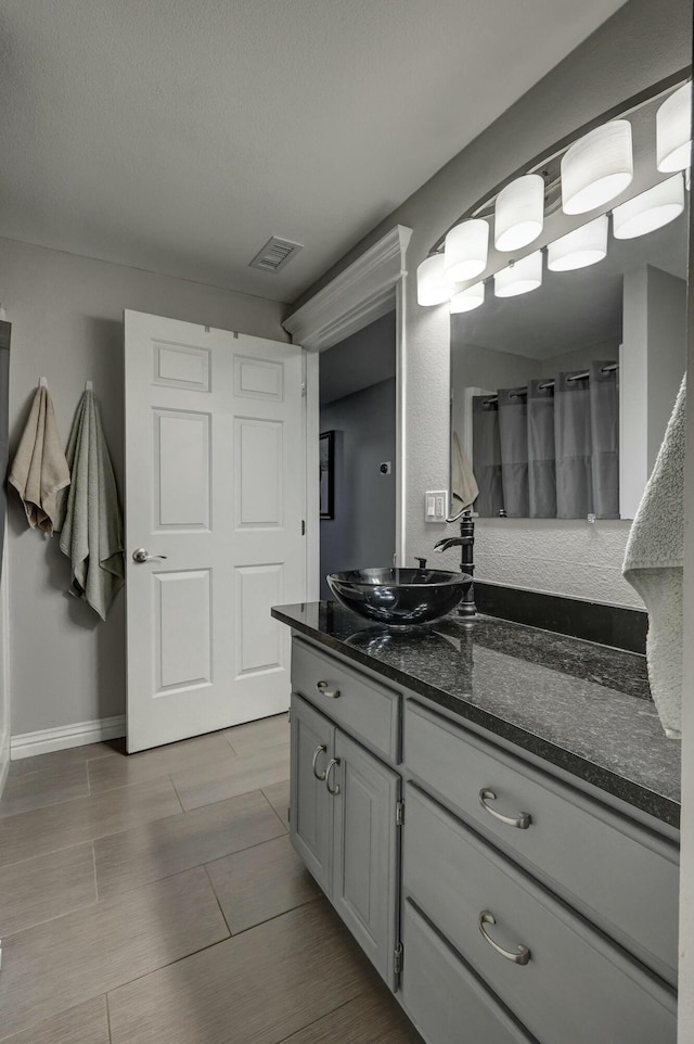 full bathroom featuring vanity, visible vents, and wood finish floors