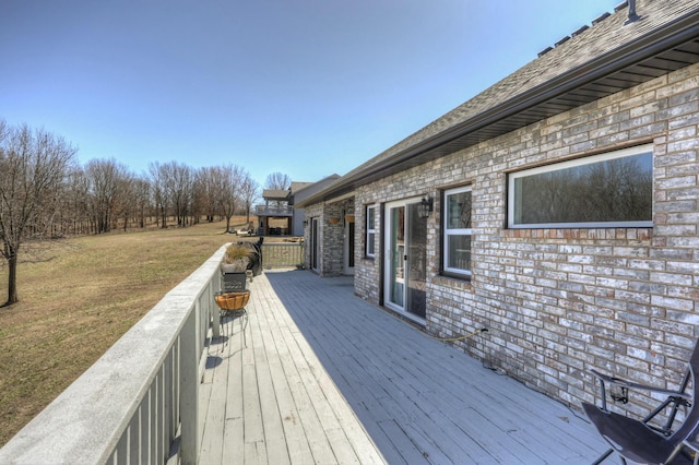 wooden deck with a yard