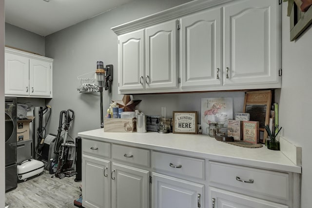 laundry room featuring light wood-type flooring