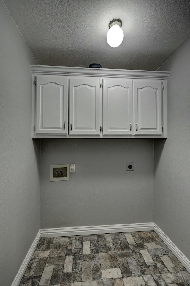 washroom featuring baseboards, cabinet space, hookup for an electric dryer, and washer hookup