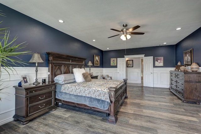 bedroom with recessed lighting, wood finished floors, and wainscoting