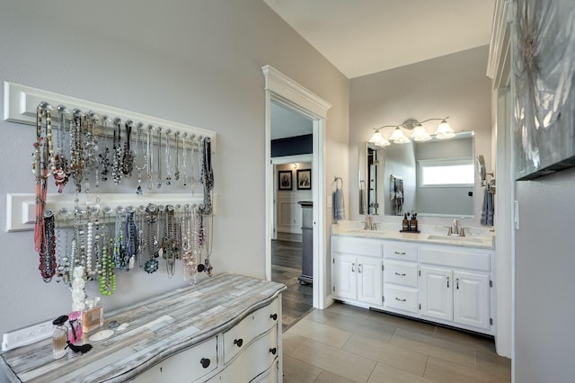 bathroom with a sink and double vanity