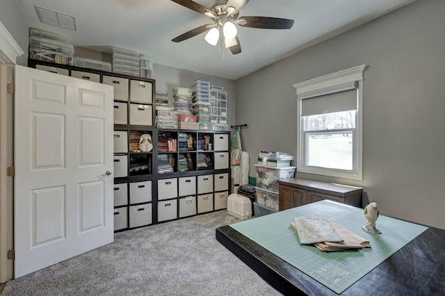 office featuring visible vents, carpet floors, and a ceiling fan