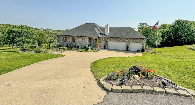 french country style house with stone siding, driveway, a front yard, and a garage