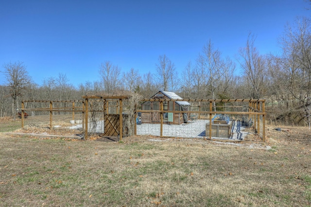 view of yard with an outbuilding, exterior structure, and fence