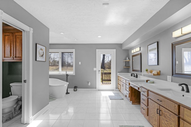 full bath featuring double vanity, tile patterned flooring, a healthy amount of sunlight, and a sink