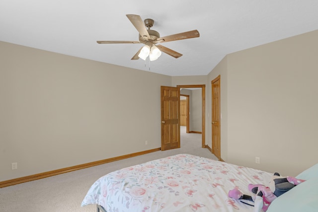 bedroom with ceiling fan, baseboards, and light carpet