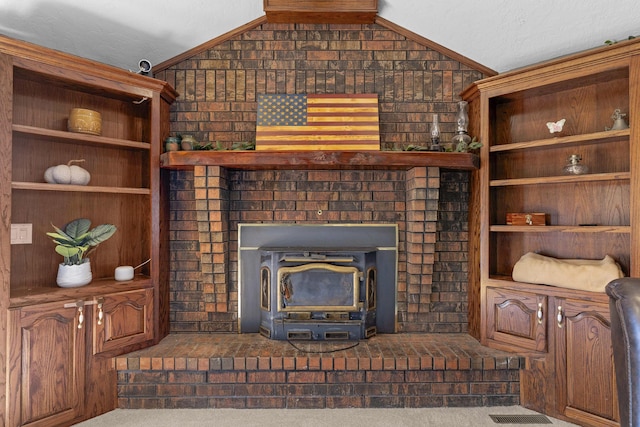 living room with visible vents, a wood stove, dark colored carpet, and vaulted ceiling