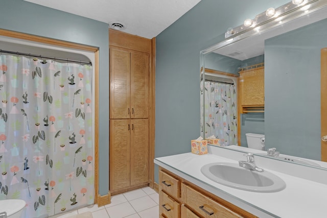 full bathroom with vanity, visible vents, curtained shower, tile patterned floors, and toilet